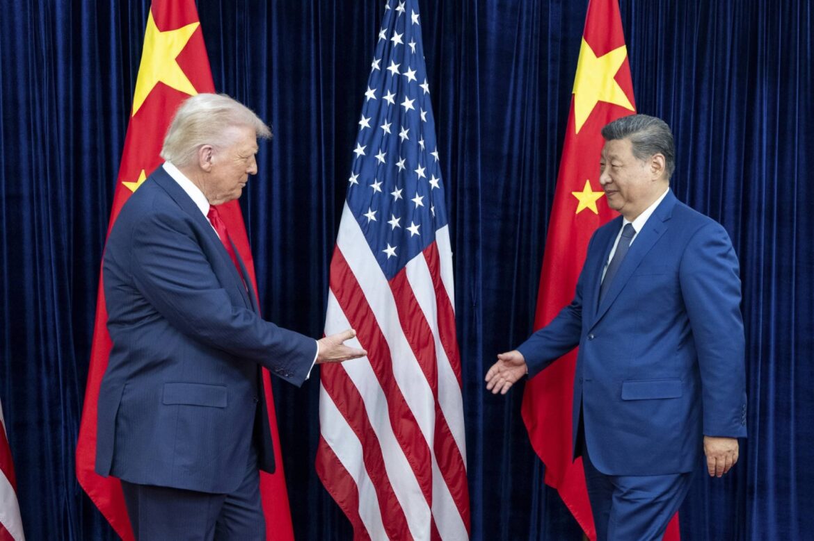 U.S. President Donald Trump greets Chinese President Xi Jinping in Busan, South Korea, on Oct. 30 last year. | HAIYUN JIANG / THE NEW YORK TIMES